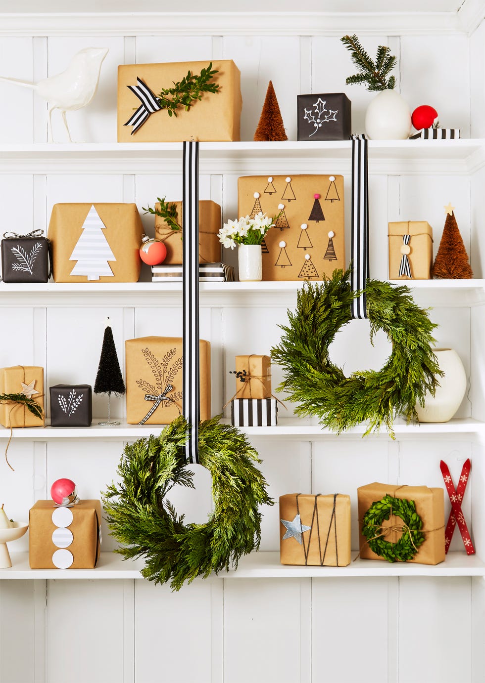 diy christmas wreaths, faux wreaths hanging from stripped ribbons on a shelf