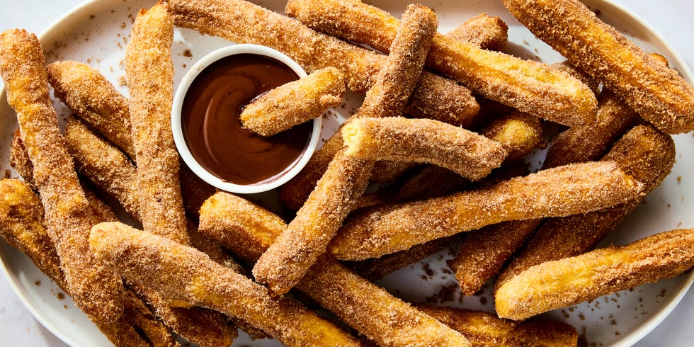 churros on a platter with chocolate dipping sauce