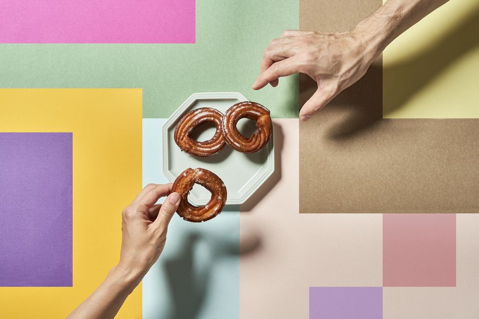 churros on a colorful background with hands