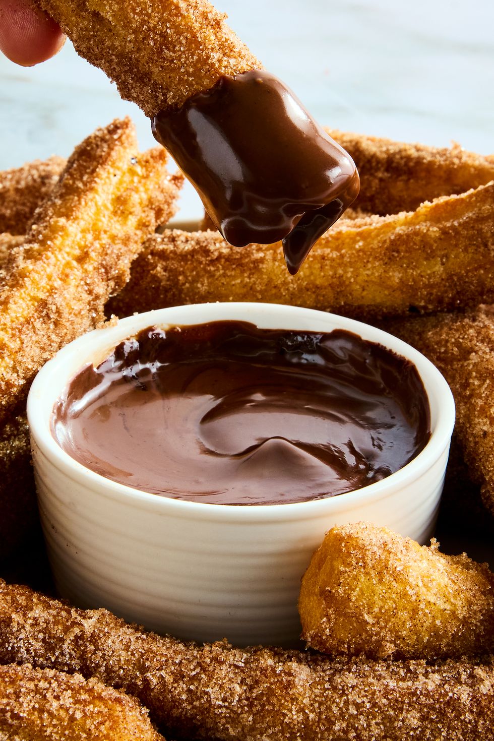 churros on a platter with chocolate dipping sauce