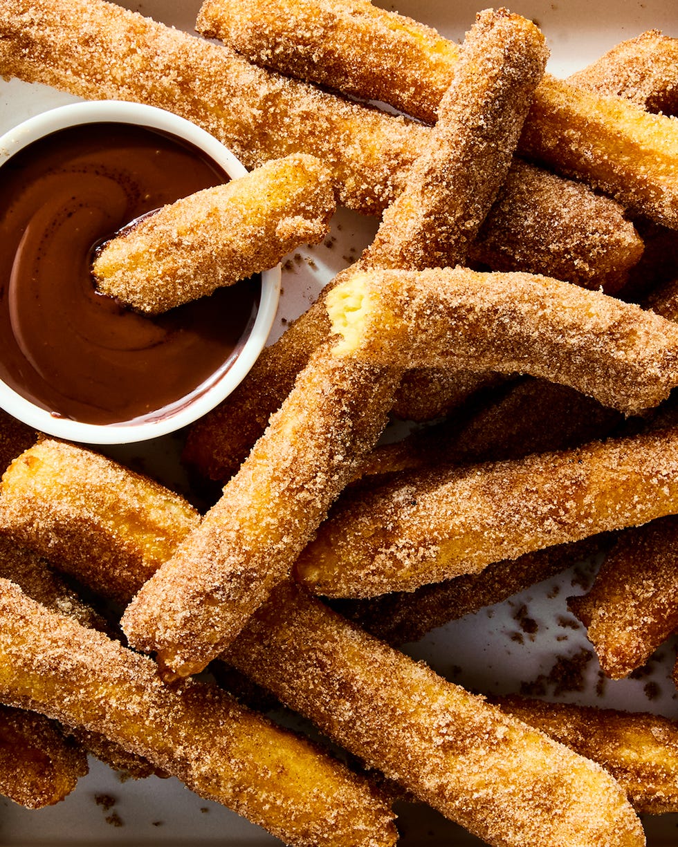 churros on a platter with chocolate dipping sauce