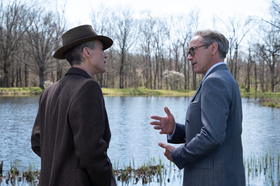 l to r cillian murphy is j robert oppenheimer and robert downey jr is lewis strauss in oppenheimer, written, produced, and directed by christopher nolan