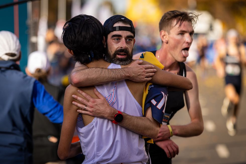 noah droddy hugs a fellow runner at the california international marathon