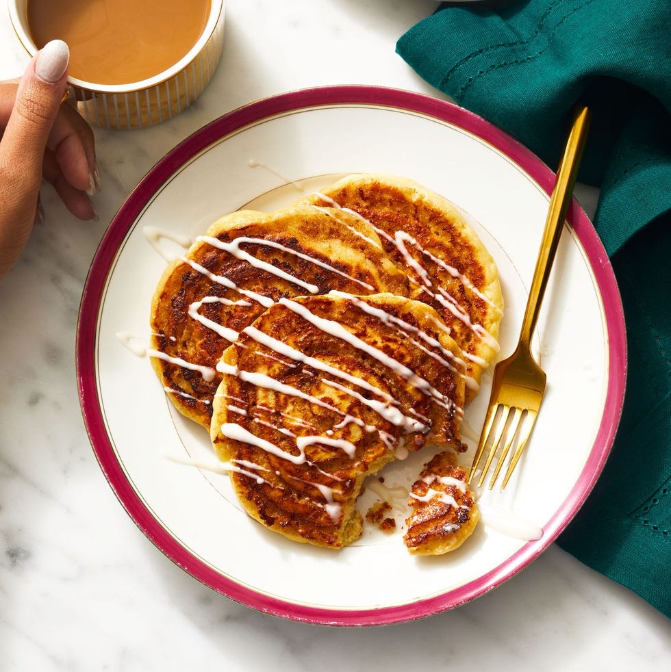 cinnamon roll pancakes with icing drizzled on top