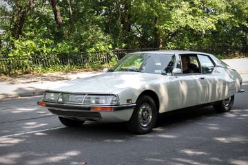 a person driving a white car
