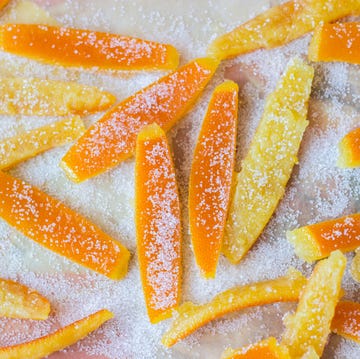 homemade orange peel on a bed of sugar