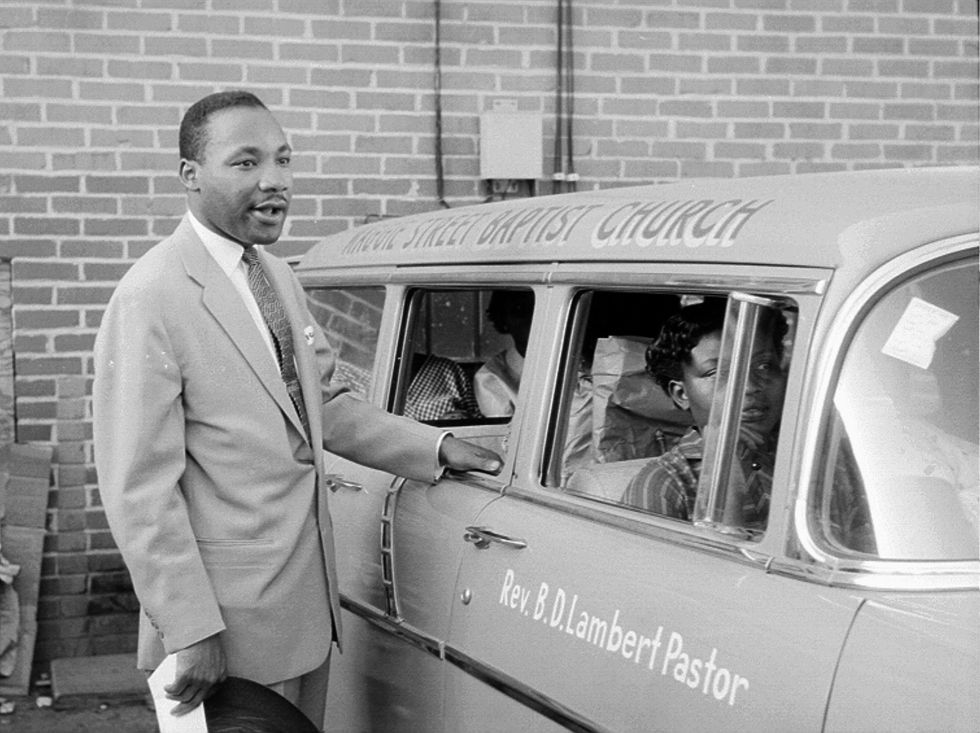 civil rights leader reverend martin luther king, jr speaks with people in a car after delivering a sermon on may 13, 1956 in montgomery, alabama