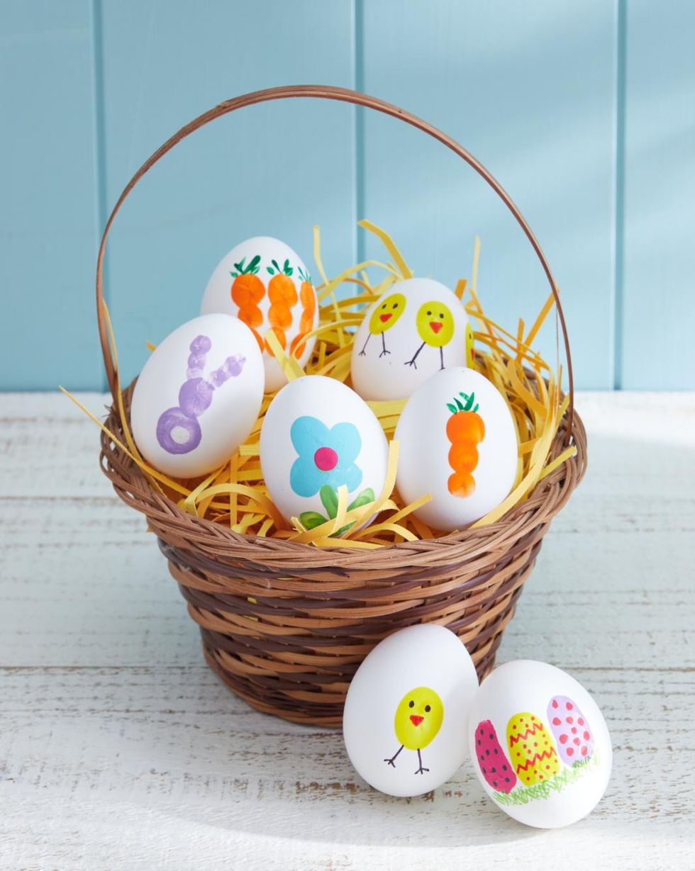 eggs decorated with kids fingerprints in a woven basket