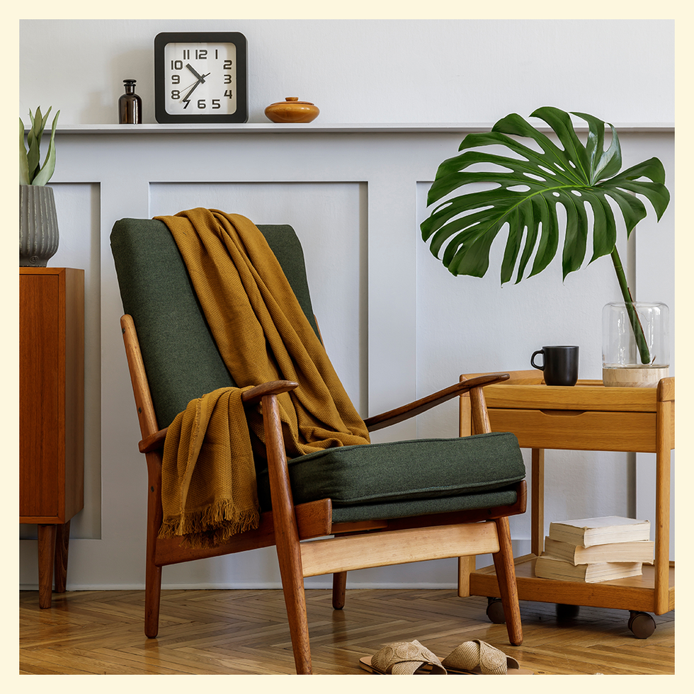 green chair in front of wood panelled wall
