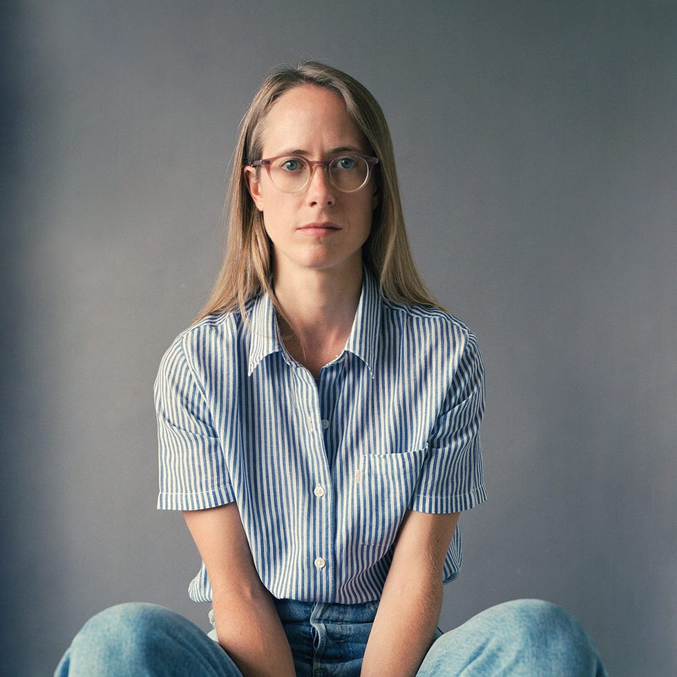 portrait of a person with long hair wearing a striped shirt