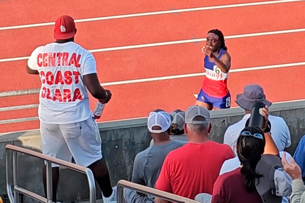 track athlete receiving support from the stands during a competition