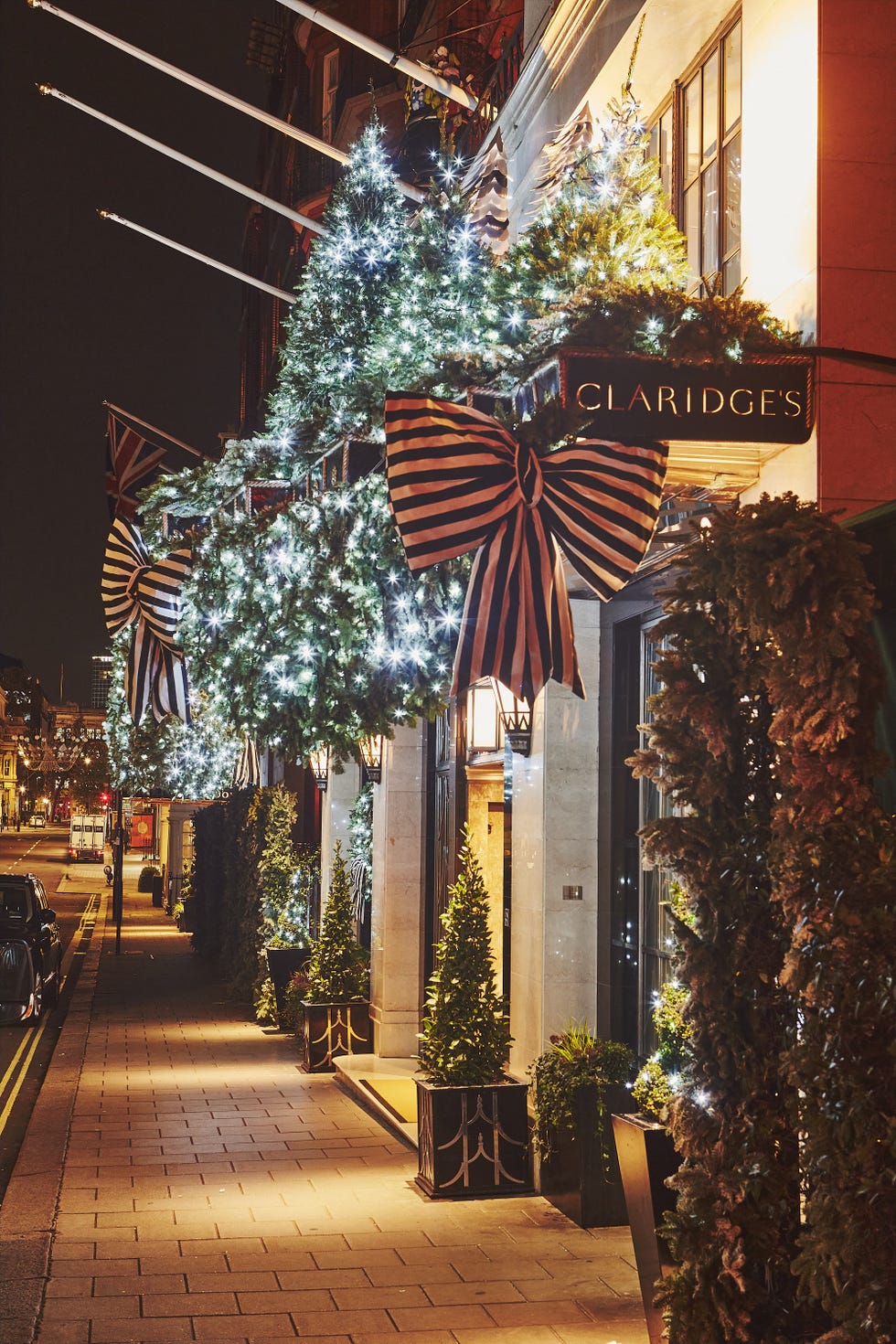 festively decorated hotel entrance with christmas trees and lights