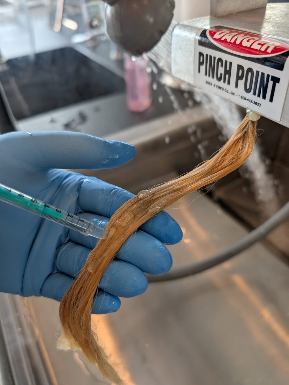 an image of a hair swatch testing shampoos in the good housekeeping institute beauty lab