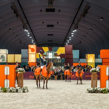 a group of people on horses in a large building