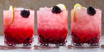 classic bramble cocktail in a cup with ice with a lemon garnish
