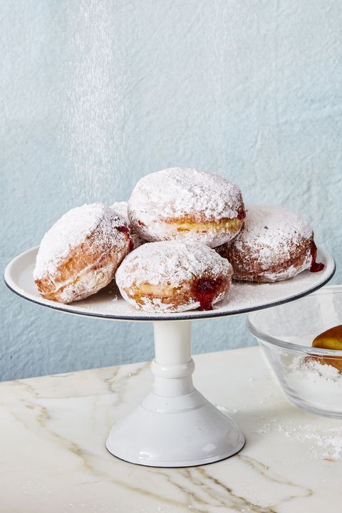 classic jelly donuts on a white cake stand