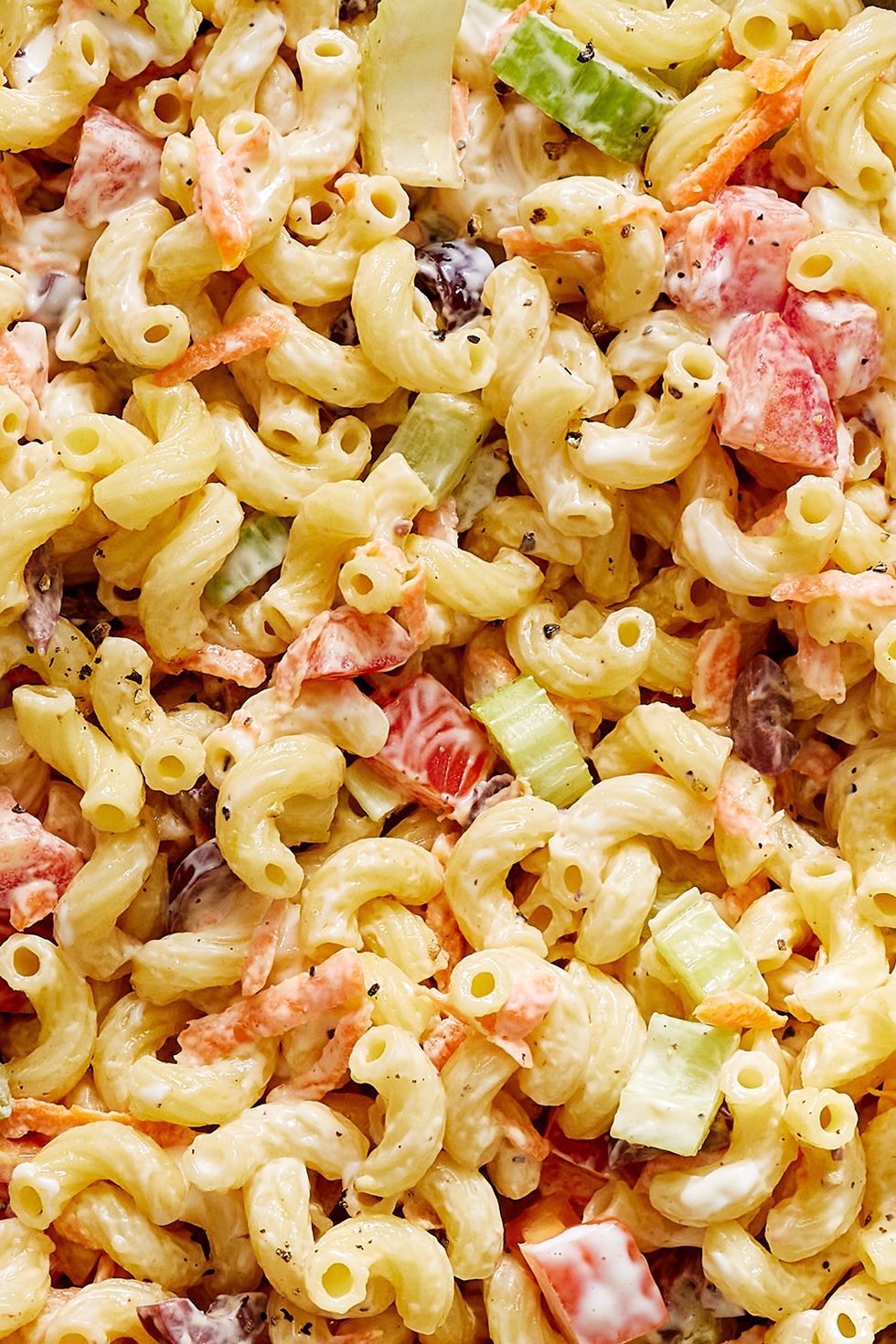 creamy macaroni salad with carrots, celery, and olives