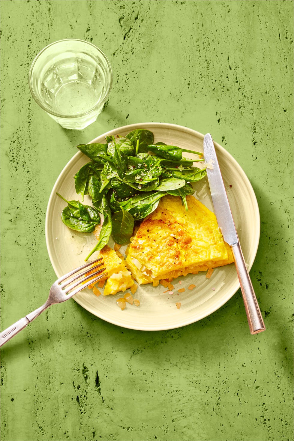 classic omelet and greens on a white plate