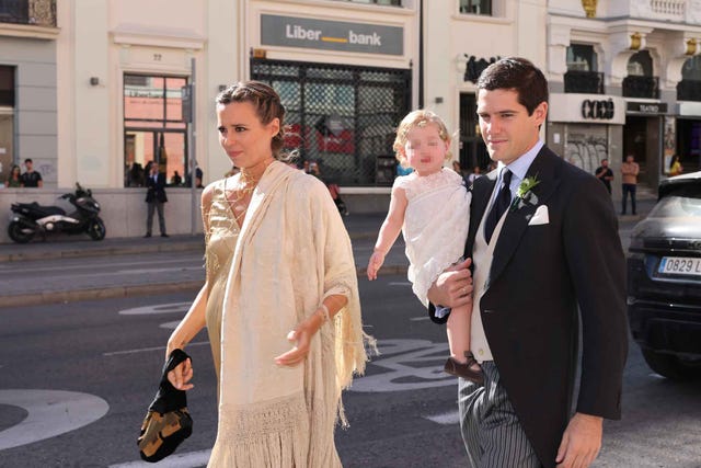 a man and woman walking down a street with a man holding a woman