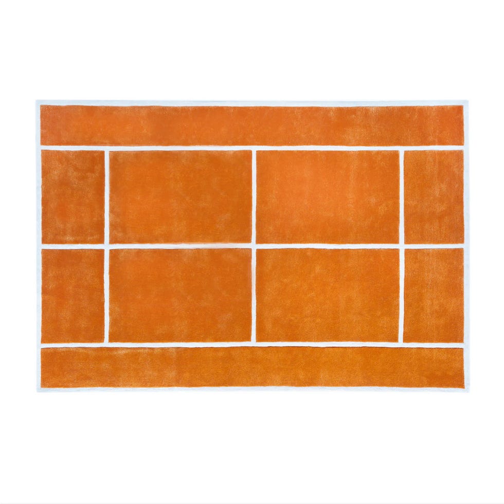 abstract rug featuring orange color blocks separated by white lines