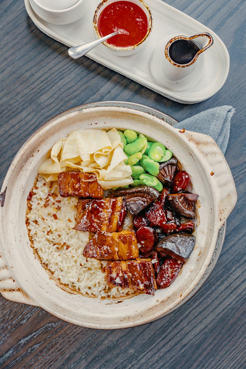 a bowl of rice topped with various meats and vegetables