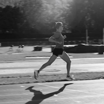 runner in motion on a track during daytime runner in motion on a track during daytime