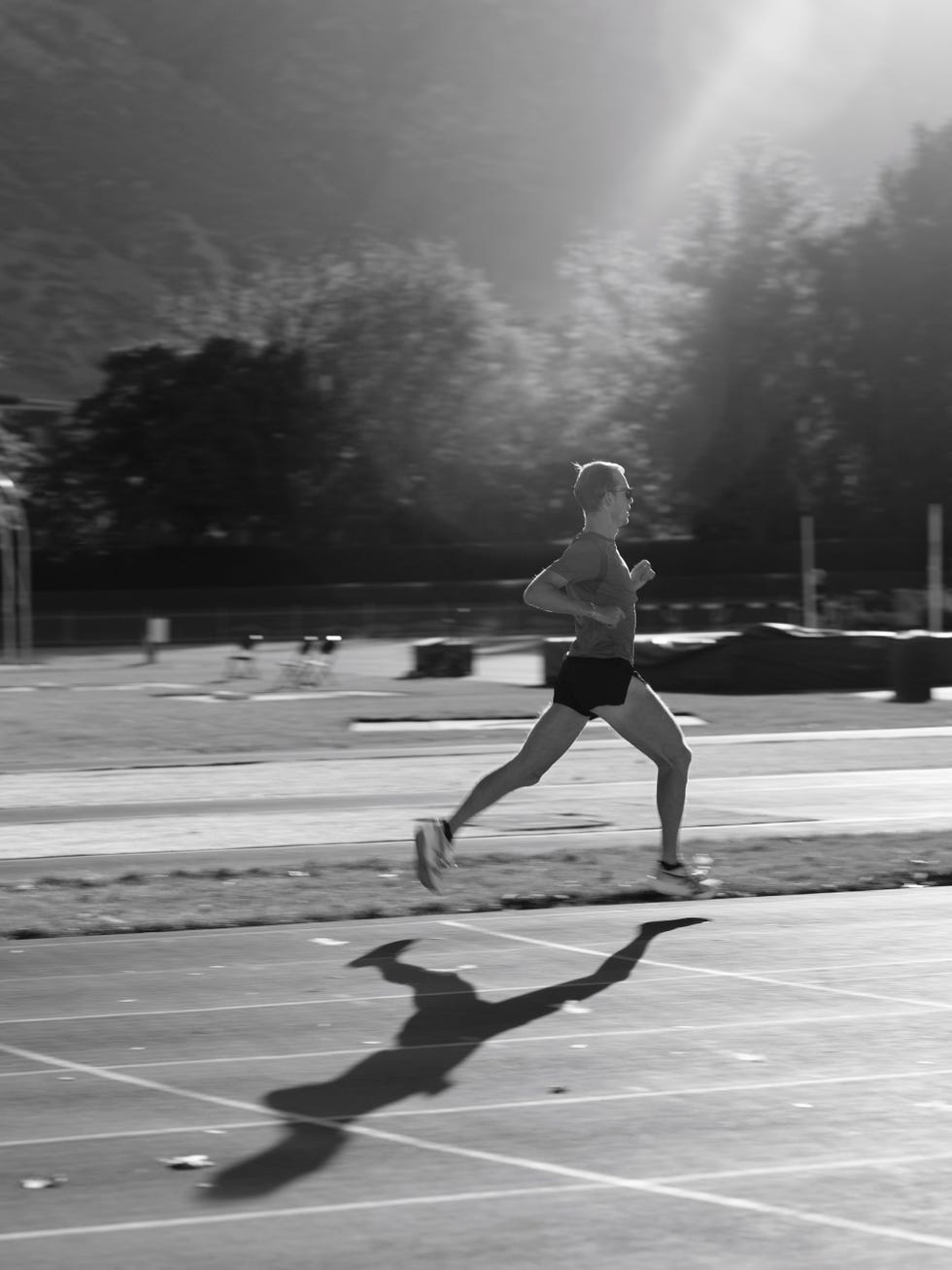 runner in motion on a track during daytime