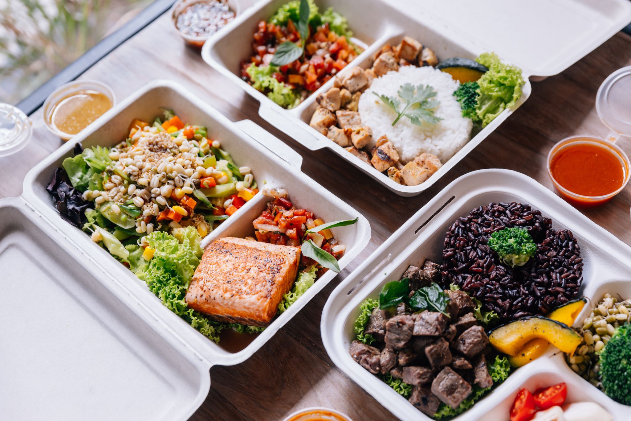 clean food meal boxes rice and rice berry with beef, salmon and chicken in various vegetables and salad for good health