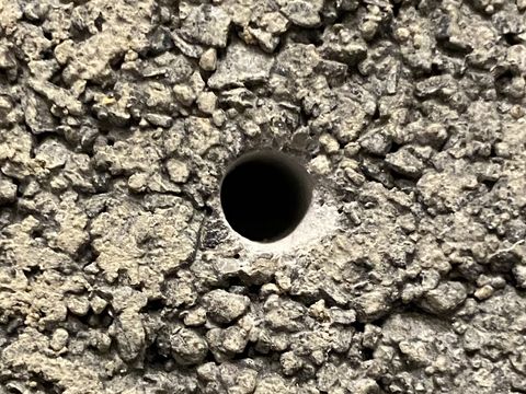 clean hole drilled in concrete block