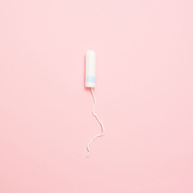Clean white cotton tampons on pink background. Menstruation. Feminine Hygiene in periods, beauty treatment.