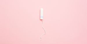 Clean white cotton tampons on pink background. Menstruation. Feminine Hygiene in periods, beauty treatment.