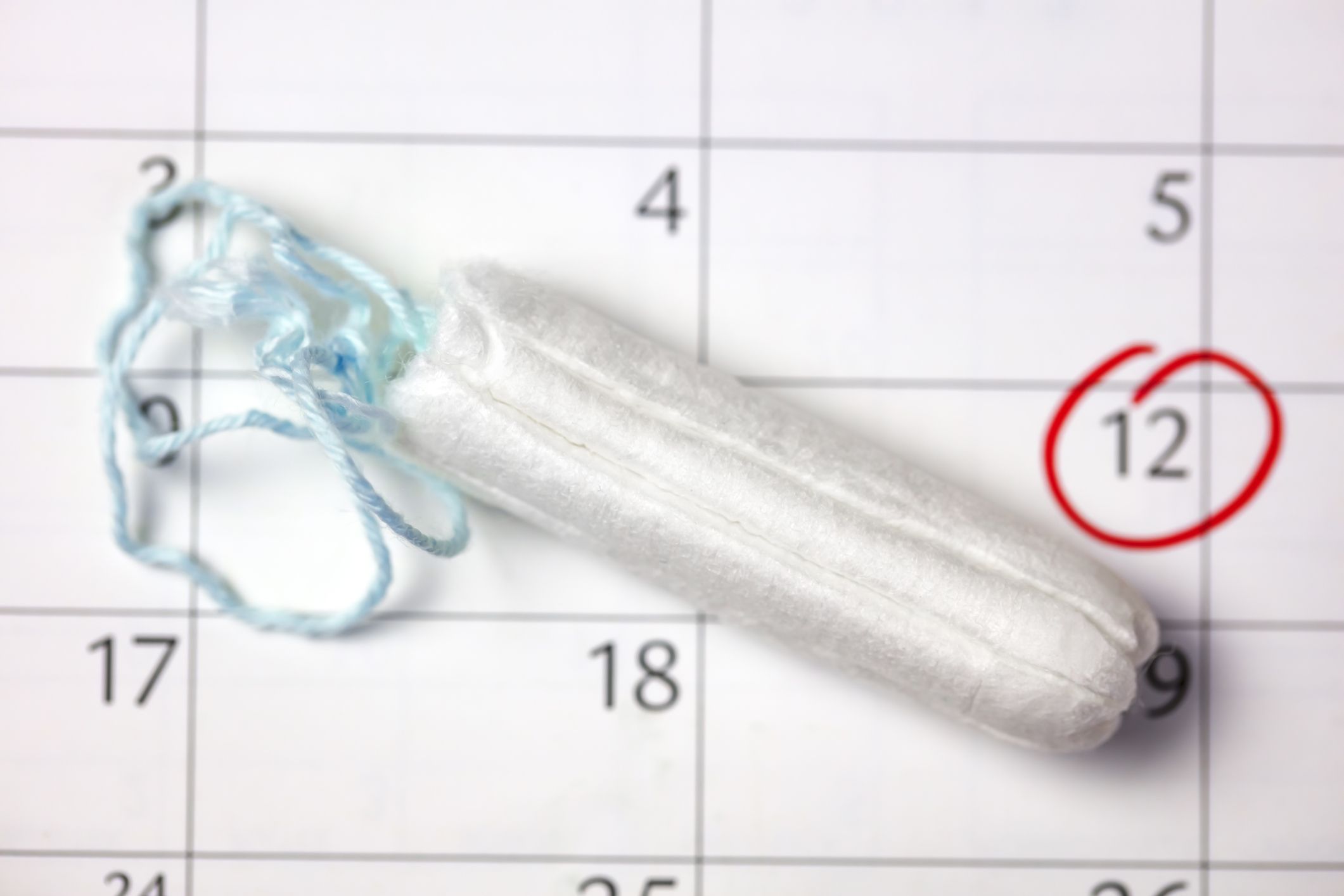 clean white tampons, mobile phone and calendar