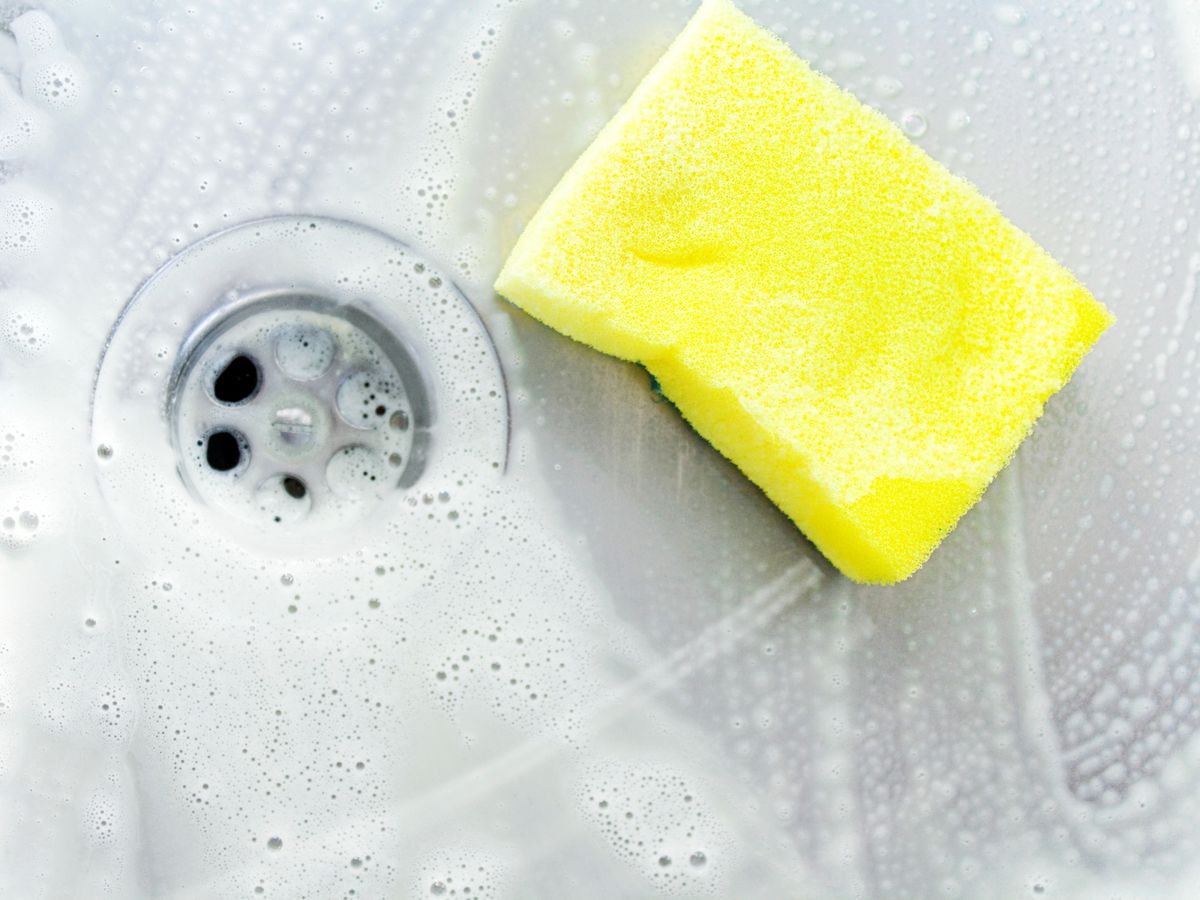 https://hips.hearstapps.com/hmg-prod/images/cleaning-a-sink-with-yellow-sponge-royalty-free-image-154933627-1566240377.jpg?crop=0.88889xw:1xh;center,top&resize=1200:*