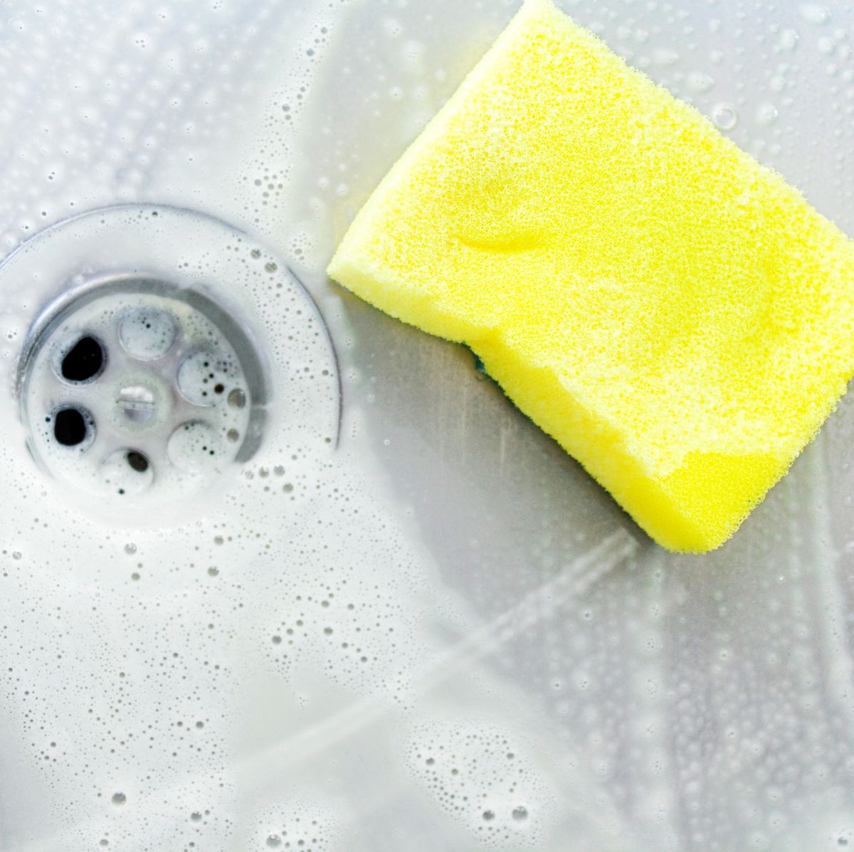 https://hips.hearstapps.com/hmg-prod/images/cleaning-a-sink-with-yellow-sponge-royalty-free-image-1681765892.jpg?crop=0.668xw:1.00xh;0.245xw,0&resize=1200:*