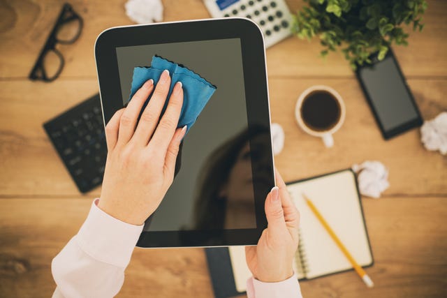 Woman cleaning a tablet - tech cleaning tips