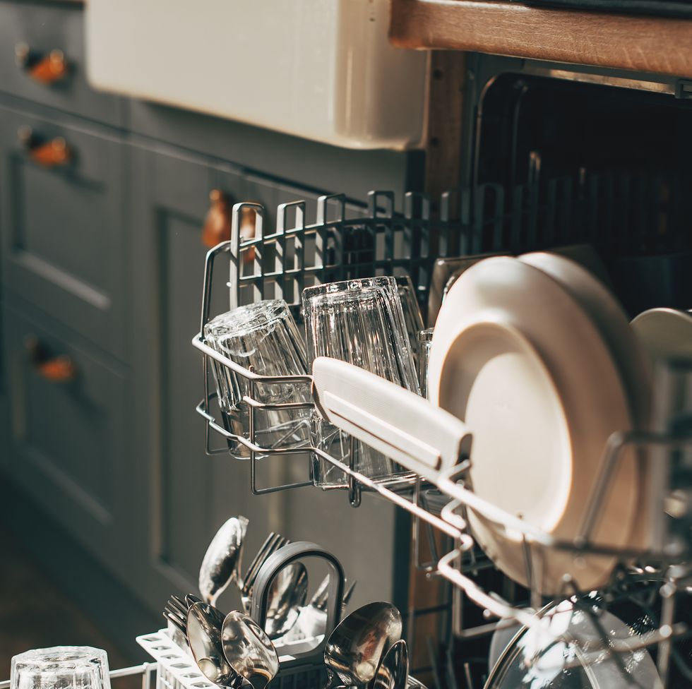 open dishwasher with clean utensils in it