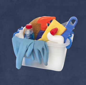a box of cleaning products bleach, rubber gloves, sprays and sponges