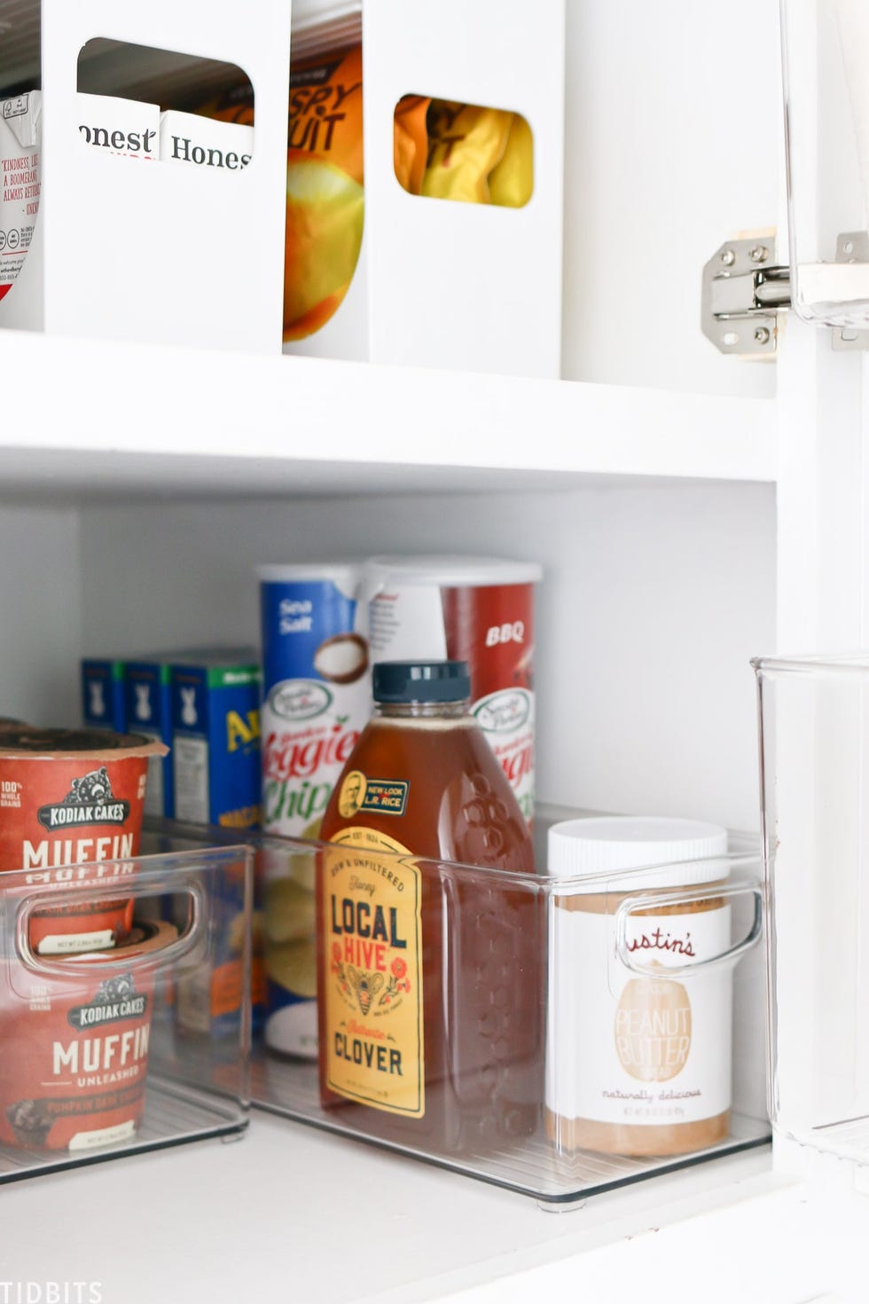 organized pantry shelf with clear containers and various food items