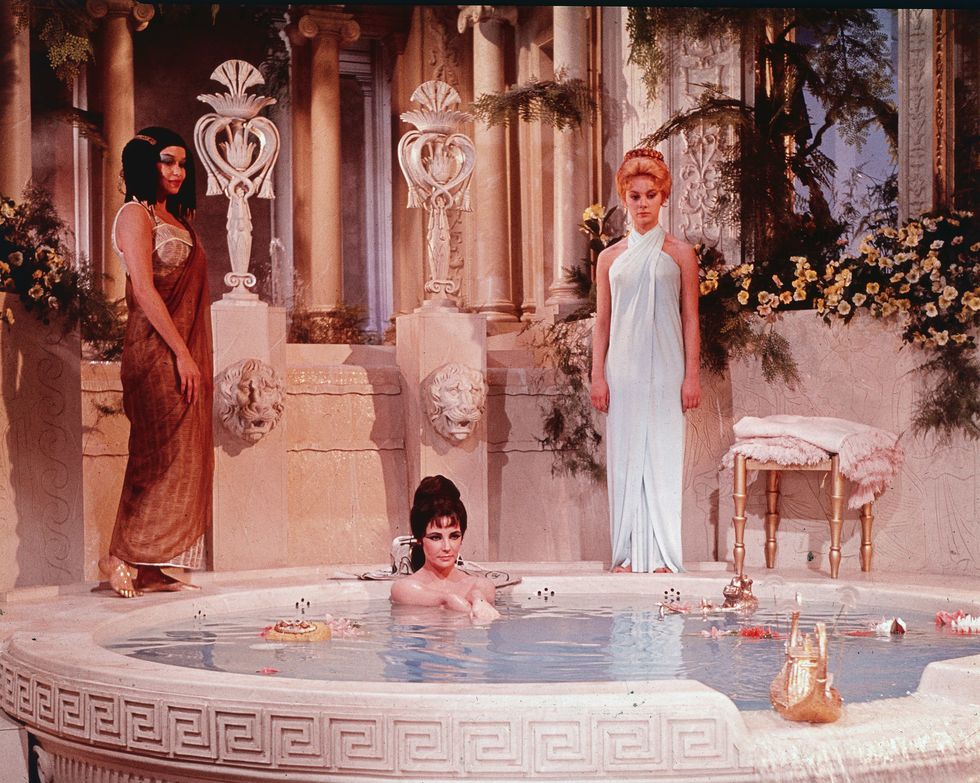 actor elizabeth taylor takes a bath in a tub with two unidentified women behind her in a still from the film, 'cleopatra,' directed by joseph mankiewitz, 1963 photo by 20th century foxcourtesy of getty images
