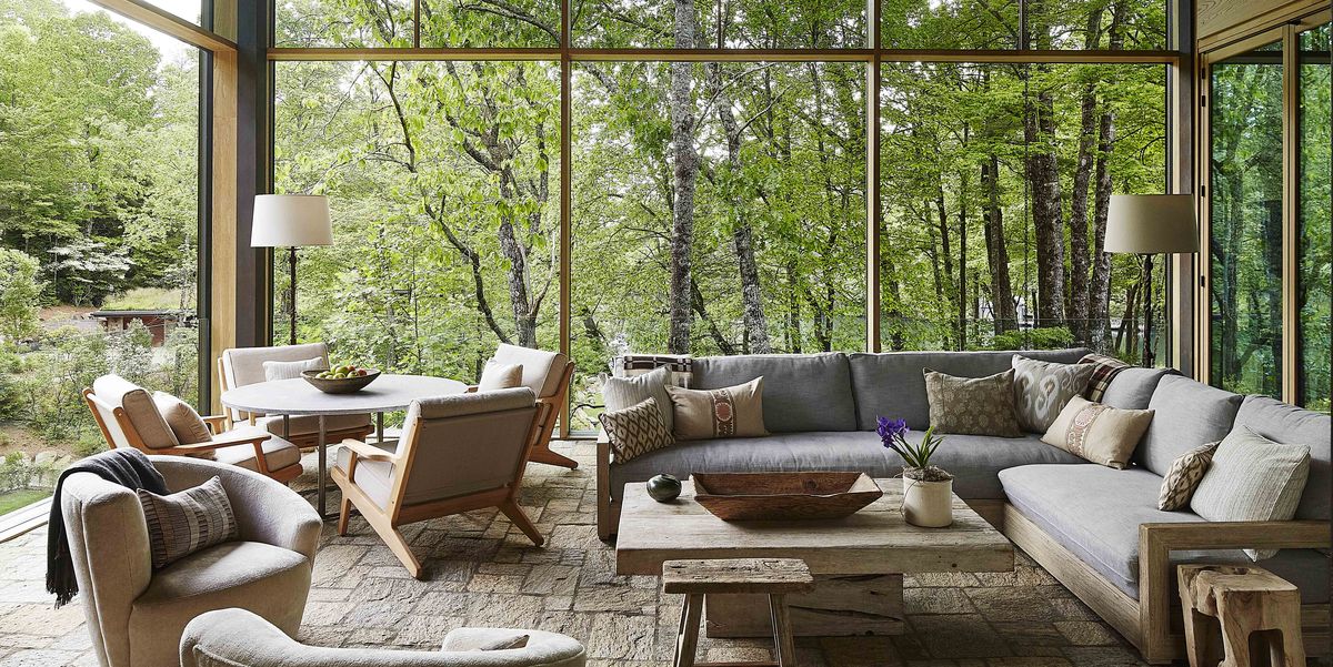 sitting area with sofa chairs and table overlooking wooded area
