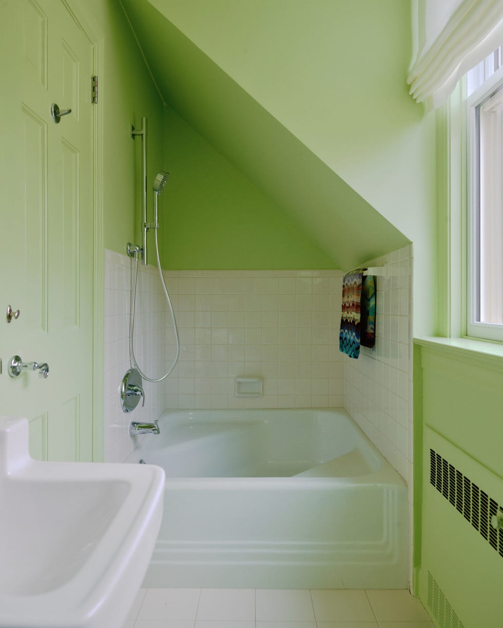 bathroom with a green color scheme and a bathtub