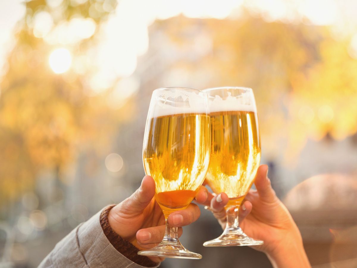 https://hips.hearstapps.com/hmg-prod/images/close-up-couple-toasting-beer-glasses-at-autumn-royalty-free-image-713774755-1548173706.jpg?crop=0.88889xw:1xh;center,top&resize=1200:*