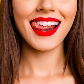 close up cropped photo of gorgeous person tongue lick teeth beaming smile isolated on yellow color background
