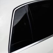 A close-up detail of a white luxury car