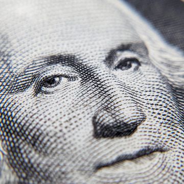 close up detail of george washington's portrait as appears on the one dollar bill