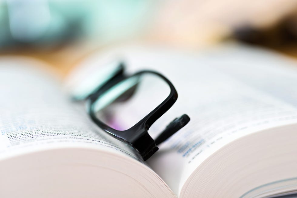Close up glasses and open book