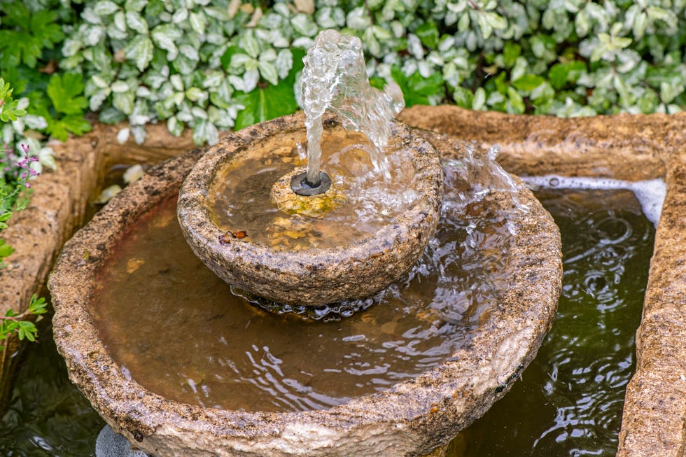 close up image of a stone water feature with bubble fountain