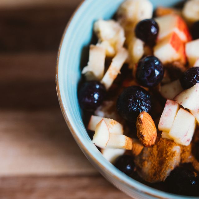close up of a bowl of porridge with fruits