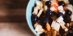 close up of a bowl of porridge with fruits