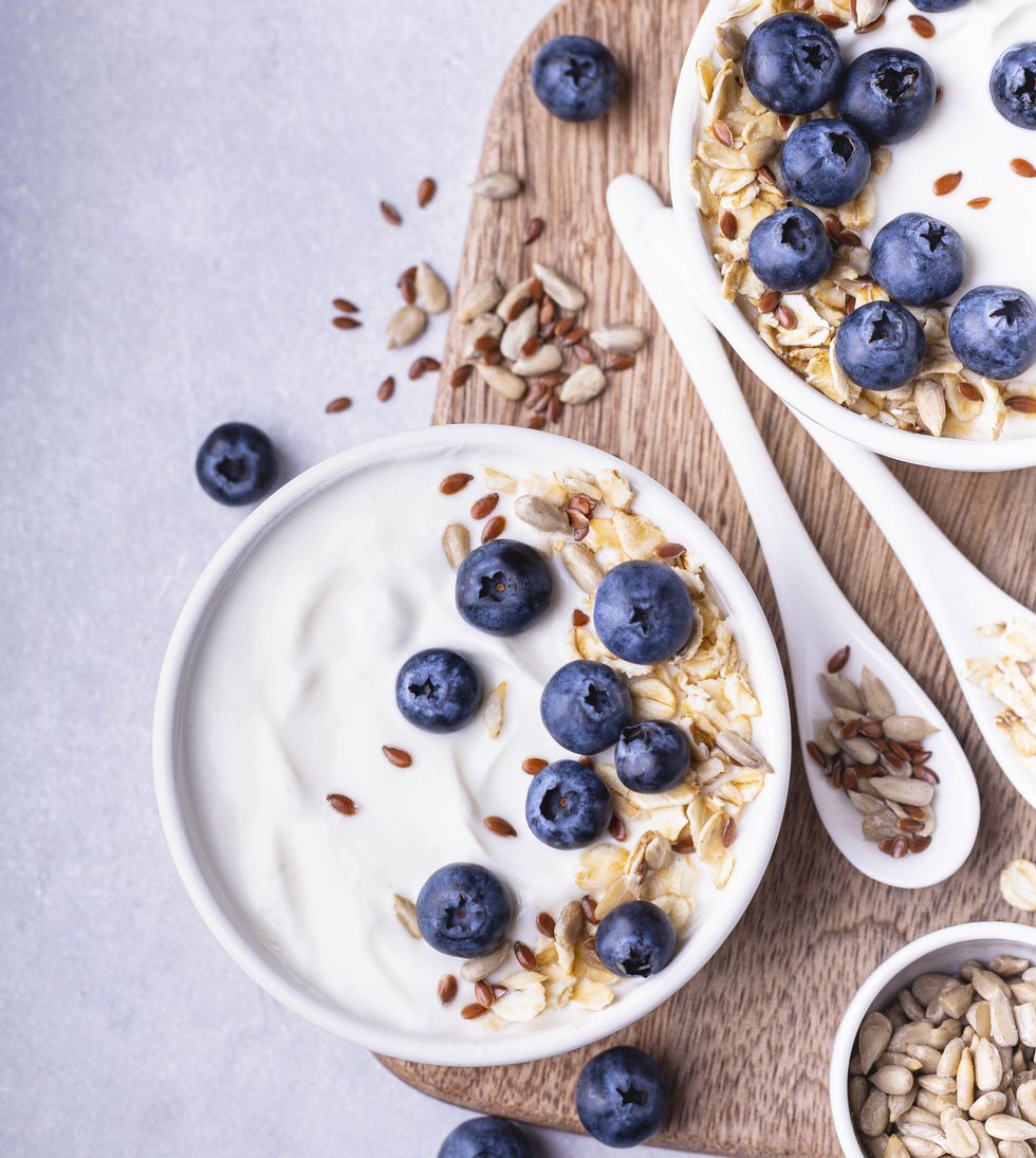 close up of a bowl with natural yogurt and some fresh blueberries